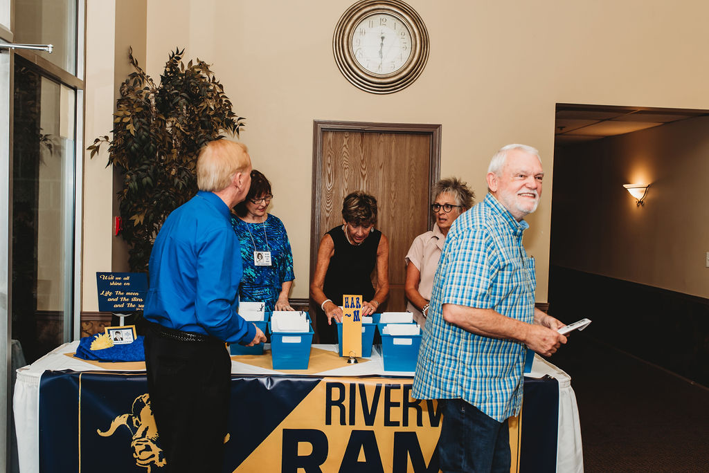 Reception Table: Nancy Jackson, Patty Geller and Runa Caquelard (members of The Dirty Dozen) handing out Reunion Packets, and Ray Johnston and Wayne Lanier picking up Reunion Packets