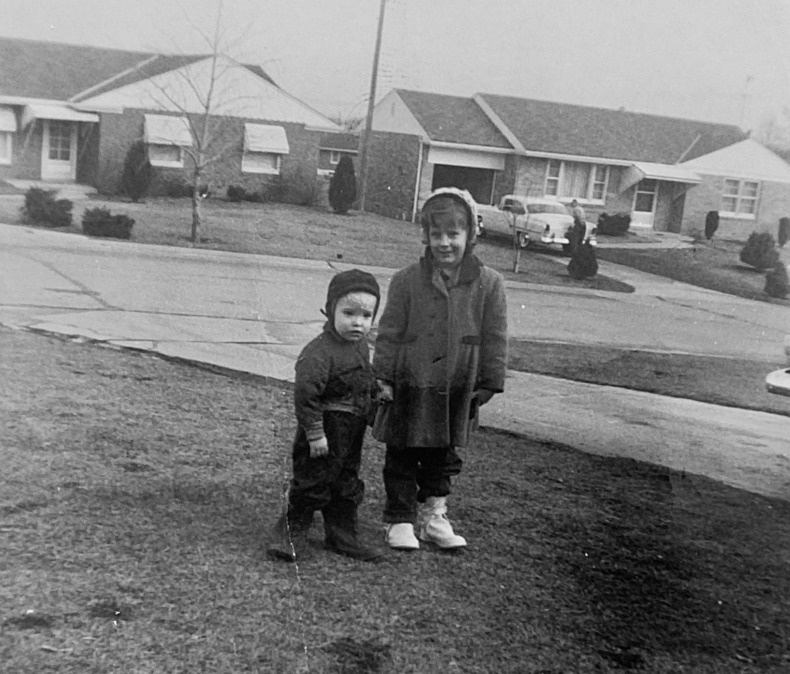 Patti Lingenfelter and her nephew, Lil Danny. In the background are two classic Hathaway Hills brick homes with awnings and one-car garages on Filibert Drive. LINGENFELTER FAMILY COLLECTION
