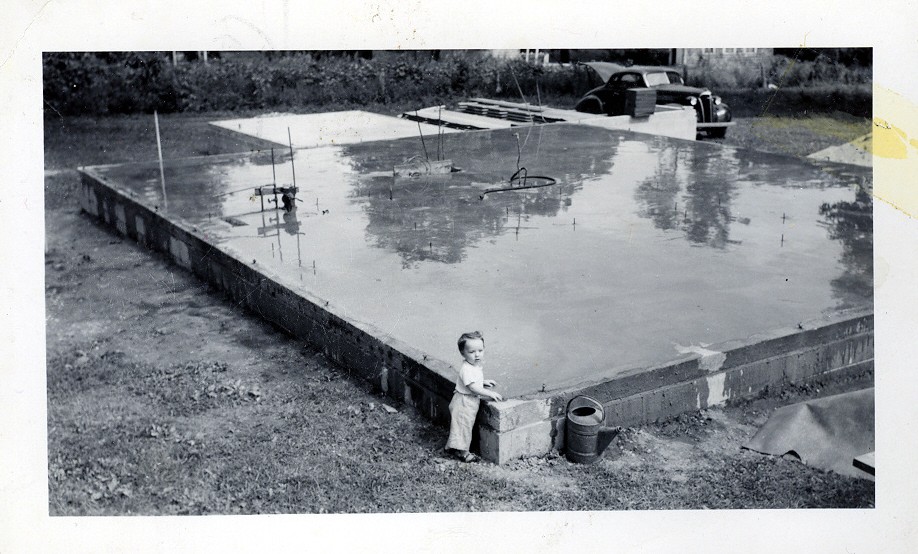 PHYLLIS MANNING (RGHS 1968)-AGE ONE, SUPERVISING THE CONCRETE SLAB POUR OF 10444 TOELLE LANE. 1951. The concrete still looks wet. MANNING FAMILY COLLECTION
